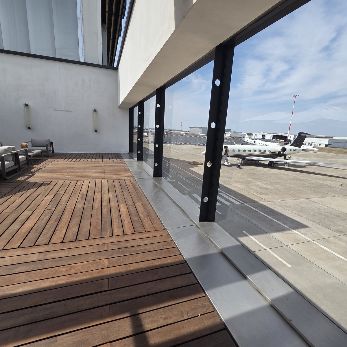 Terrasse en bord de piste avec des jets privés stationnés